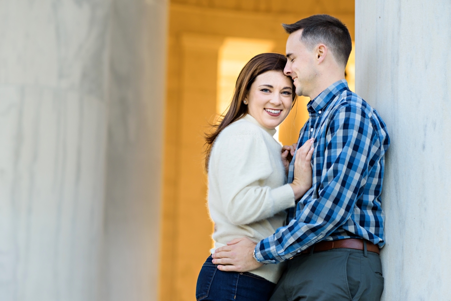 A beautiful couple holding each other in the lincoln memorial for their dc engagement session.
